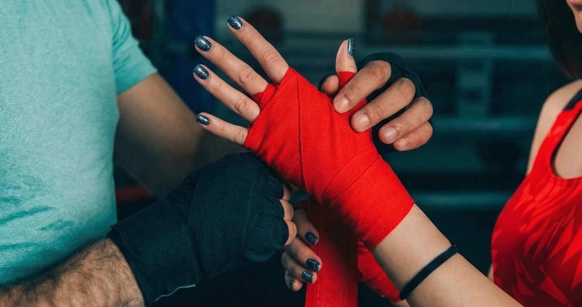 Boxer wrapping hands before training session